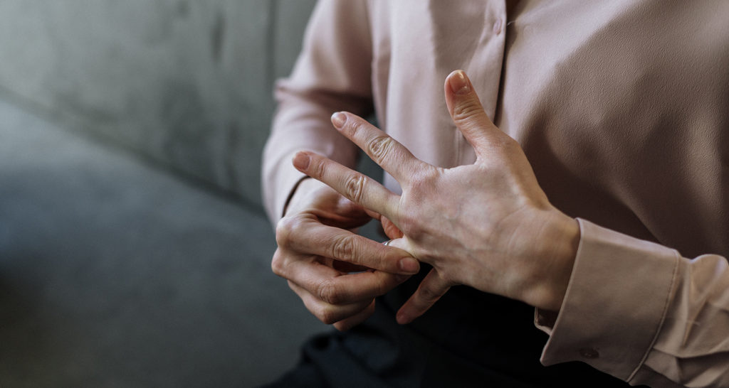 person removing wedding ring