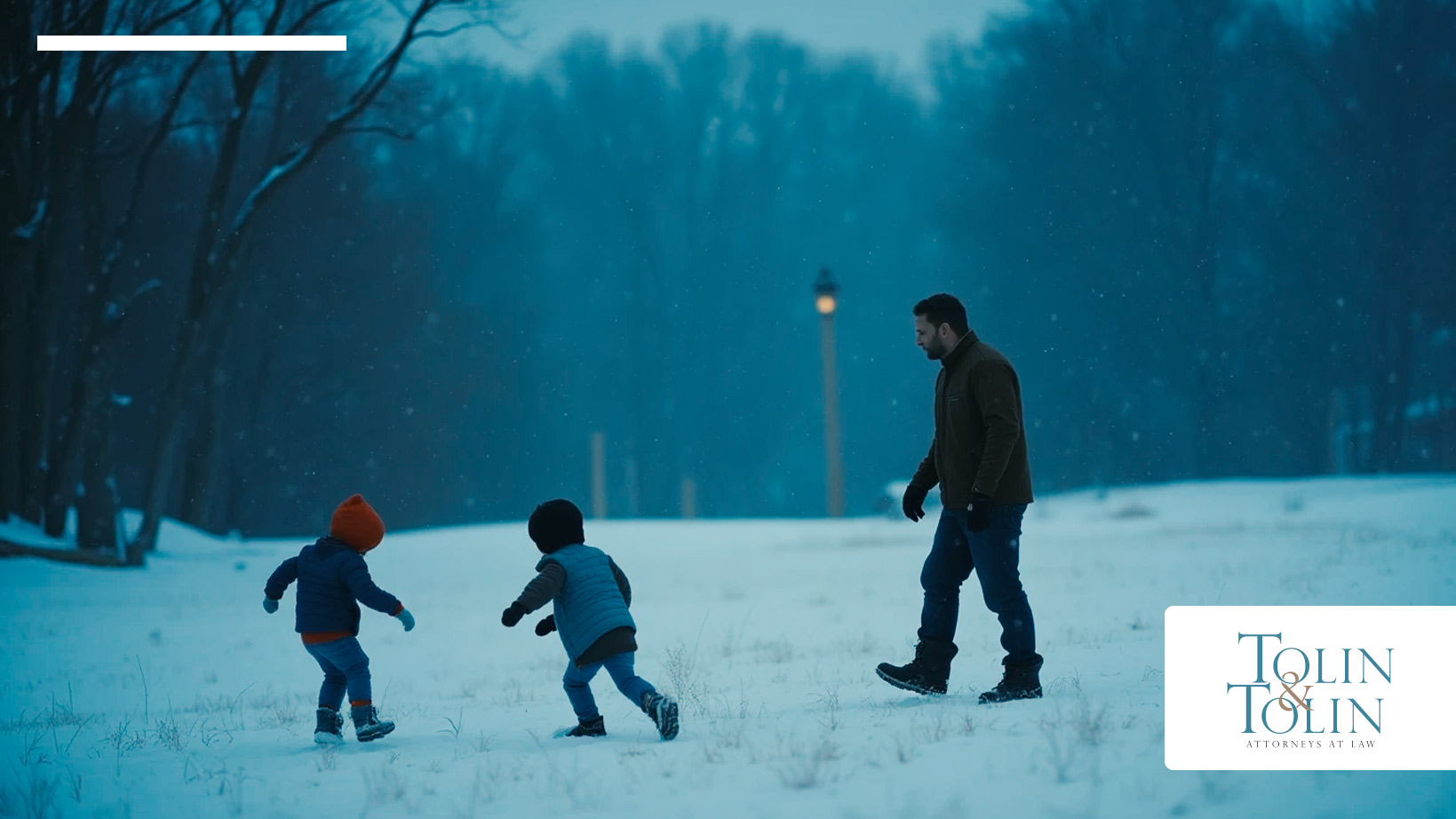Dad is playing with his two children in the snow.